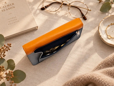Orange leather purse with navy rear zip pocket for coins