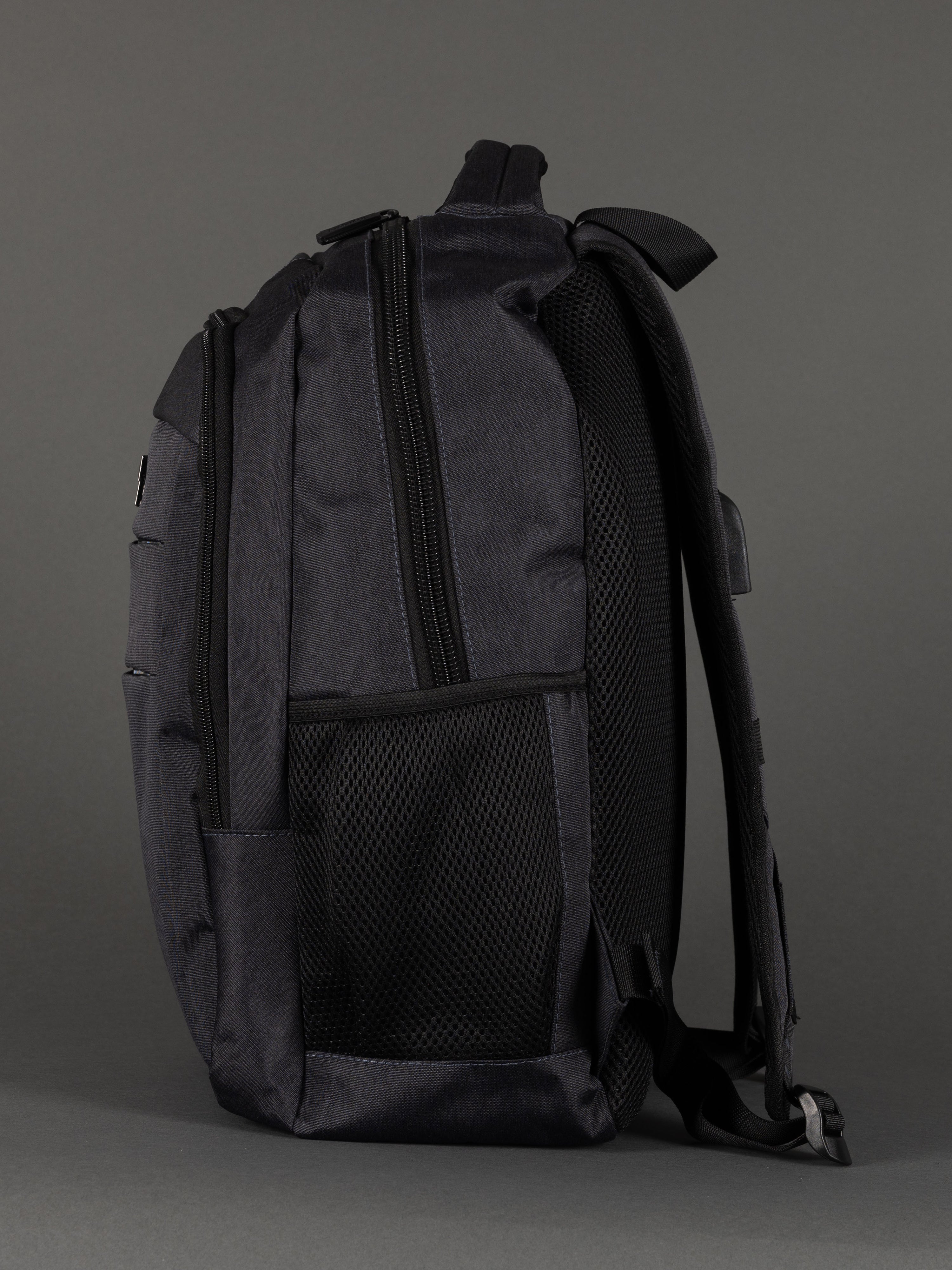 "Grey laptop backpack with padded laptop compartment and USB charging"